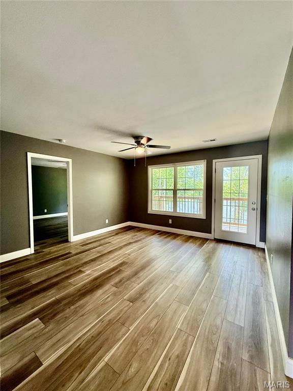 400 E Deerwood Drive 400 & 402, Jackson, MO 63755 - spare room featuring wood finished floors and ceiling fan