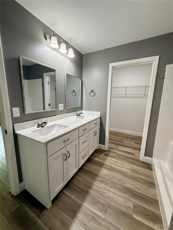 400 E Deerwood Drive 400 & 402, Jackson, MO 63755 - full bathroom with double vanity, a spacious closet, and wood finished floors