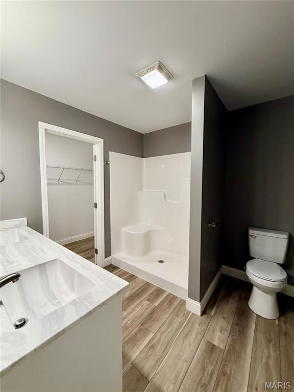 400 E Deerwood Drive 400 & 402, Jackson, MO 63755 - bathroom featuring wood finished floors, vanity, a spacious closet, and a shower