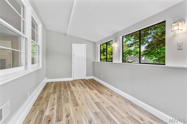701 Hillsboro Rd, Farmington, MO 63640 - empty room featuring lofted ceiling, wood finished floors, and baseboards