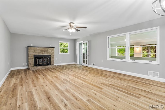 701 Hillsboro Rd, Farmington, MO 63640 - unfurnished living room featuring a ceiling fan, wood finished floors, baseboards, and a stone fireplace