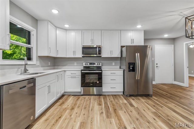 701 Hillsboro Rd, Farmington, MO 63640 - kitchen with appliances with stainless steel finishes, a sink, light countertops, white cabinets, and recessed lighting