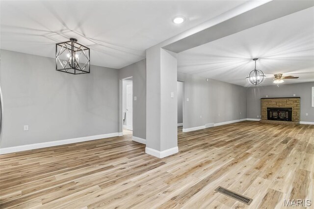 701 Hillsboro Rd, Farmington, MO 63640 - unfurnished living room with a chandelier, baseboards, and wood finished floors