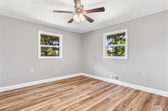701 Hillsboro Rd, Farmington, MO 63640 - unfurnished room featuring healthy amount of natural light, baseboards, light wood-style floors, and a ceiling fan