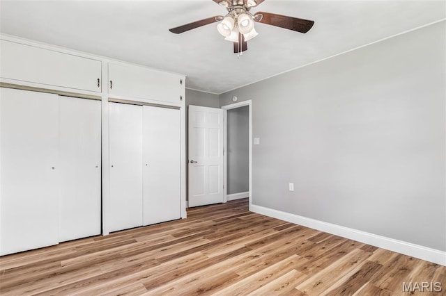 701 Hillsboro Rd, Farmington, MO 63640 - unfurnished bedroom with two closets, light wood-style floors, baseboards, and ceiling fan