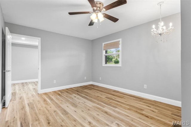 701 Hillsboro Rd, Farmington, MO 63640 - empty room with baseboards, light wood-style flooring, a ceiling fan, and a chandelier