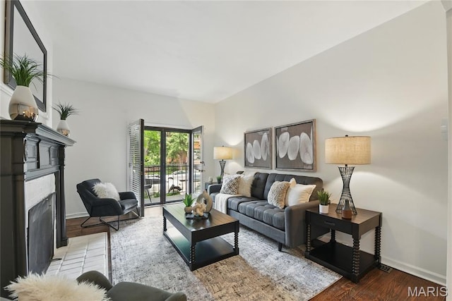 10 N Taylor Ave # 1S, Saint Louis, MO 63108 - living room featuring a fireplace with flush hearth, wood finished floors, and baseboards