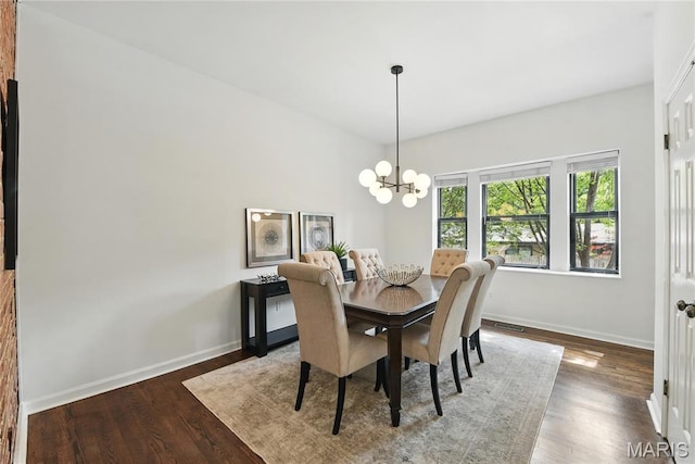 10 N Taylor Ave # 1S, Saint Louis, MO 63108 - dining space with baseboards, wood finished floors, and a chandelier
