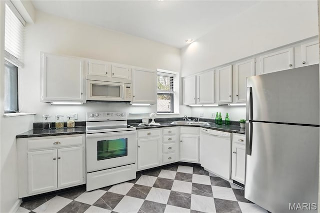 10 N Taylor Ave # 1S, Saint Louis, MO 63108 - kitchen with white appliances, a sink, white cabinets, and dark countertops