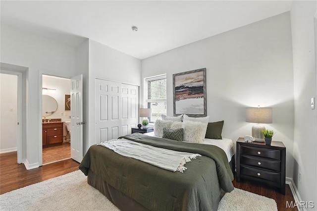 10 N Taylor Ave # 1S, Saint Louis, MO 63108 - bedroom featuring dark wood finished floors, a closet, baseboards, and ensuite bath