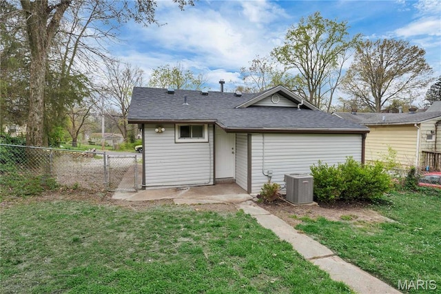 back of property with cooling unit, a gate, and roof with shingles