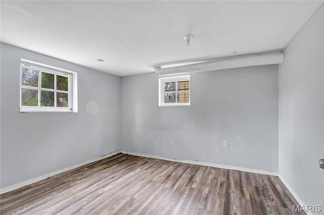below grade area featuring wood finished floors and baseboards