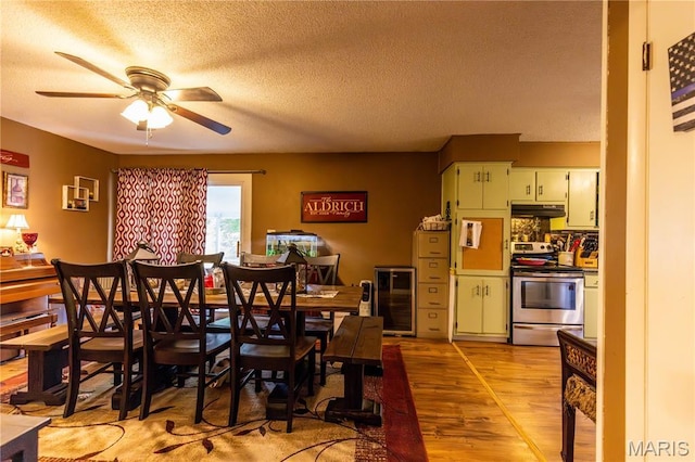 211 E Elm, Bertrand, MO 63823 - dining room featuring wine cooler, light wood-style floors, ceiling fan, and a textured ceiling