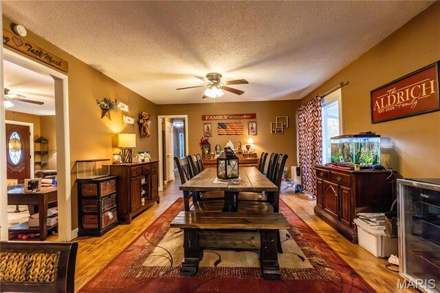 211 E Elm, Bertrand, MO 63823 - dining space with a ceiling fan, wood finished floors, and a textured ceiling