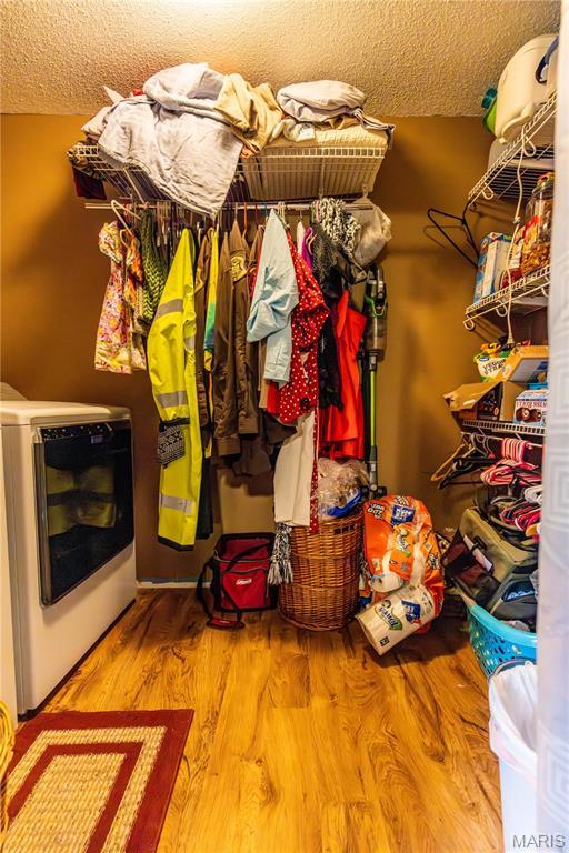 211 E Elm, Bertrand, MO 63823 - spacious closet featuring washer / clothes dryer and wood finished floors