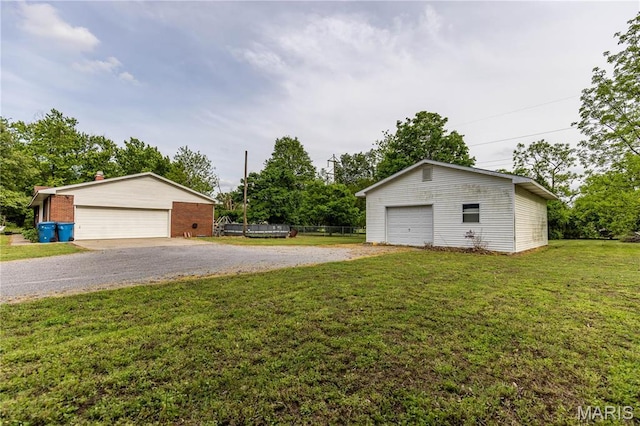211 E Elm, Bertrand, MO 63823 - view of green lawn with an outbuilding and a garage