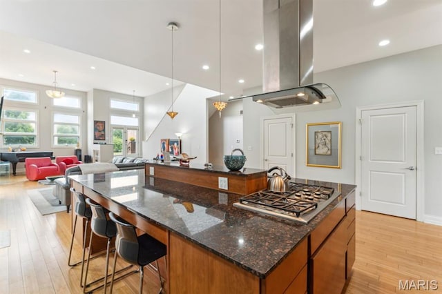 4349 Washington Blvd, Saint Louis, MO 63108 - kitchen featuring island exhaust hood, stainless steel gas cooktop, a spacious island, light wood-style floors, and open floor plan