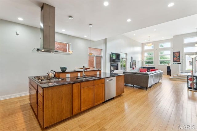 4349 Washington Blvd, Saint Louis, MO 63108 - kitchen with a sink, stainless steel appliances, island exhaust hood, brown cabinets, and light wood finished floors