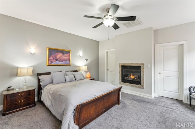4349 Washington Blvd, Saint Louis, MO 63108 - carpeted bedroom with a glass covered fireplace, baseboards, and ceiling fan