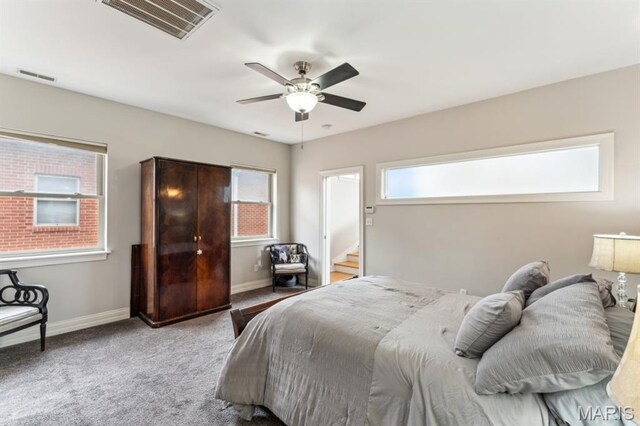 4349 Washington Blvd, Saint Louis, MO 63108 - carpeted bedroom with multiple windows, baseboards, and a ceiling fan