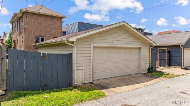 4349 Washington Blvd, Saint Louis, MO 63108 - view of front facade with a garage, fence, and an outbuilding