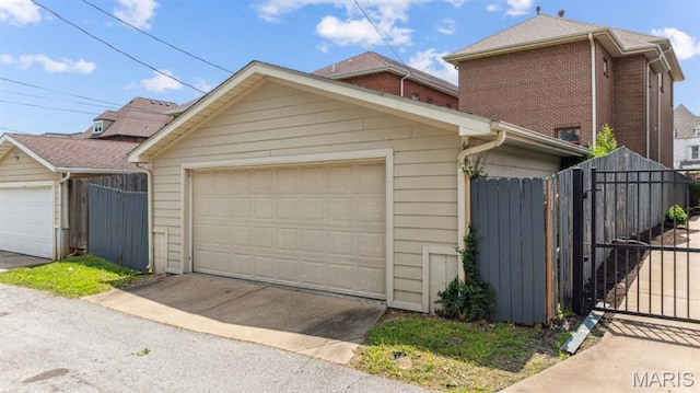 4349 Washington Blvd, Saint Louis, MO 63108 - view of front facade with fence, an outdoor structure, a gate, and a detached garage