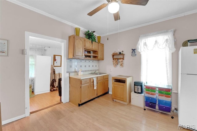 4229 Oakwood Ave, Saint Louis, MO 63121 - kitchen with freestanding refrigerator, light wood-style flooring, tasteful backsplash, crown molding, and ceiling fan