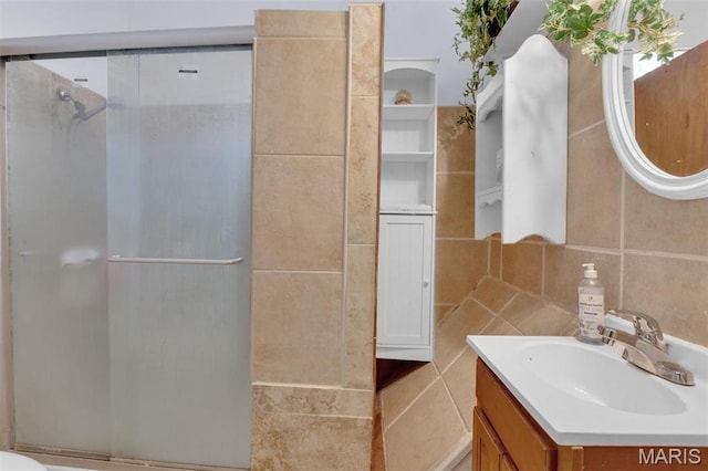 4229 Oakwood Ave, Saint Louis, MO 63121 - bathroom with vanity, a stall shower, tile walls, and backsplash