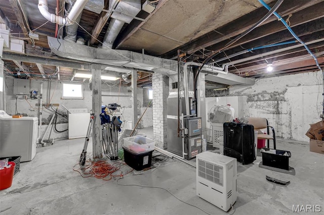 4229 Oakwood Ave, Saint Louis, MO 63121 - below grade area featuring washing machine and clothes dryer, heating unit, and electric panel