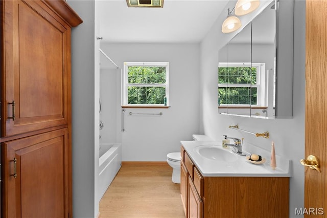 6703 Shenandoah Ln, Dittmer, MO 63023 - bathroom with vanity, wood finished floors, toilet, shower / washtub combination, and baseboards