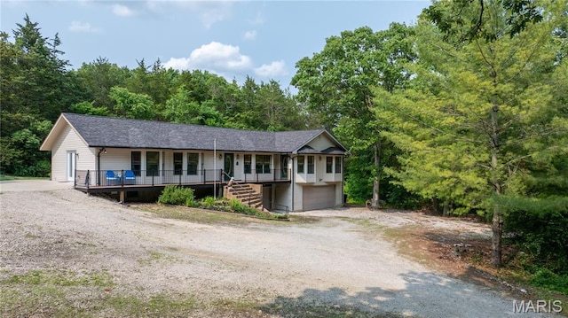 6703 Shenandoah Ln, Dittmer, MO 63023 - ranch-style home featuring a porch, stairway, a garage, driveway, and a view of trees