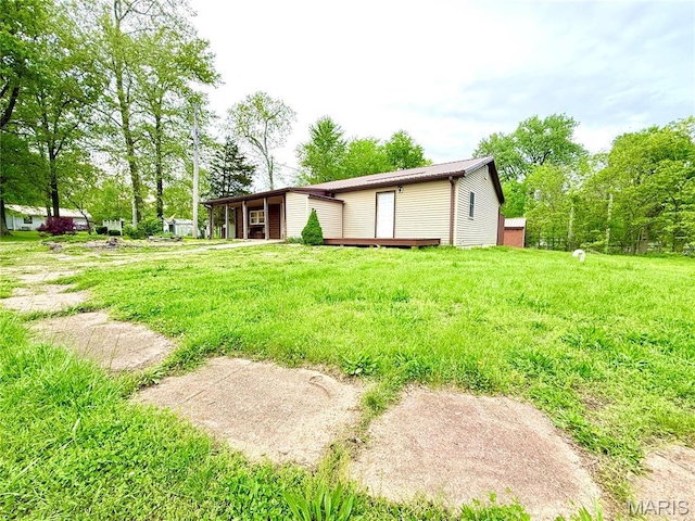 1307 Pike Dr, Bismarck, MO 63624 - back of property featuring a wooden deck and a lawn