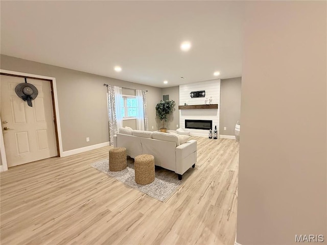 1307 Pike Dr, Bismarck, MO 63624 - living area featuring light wood finished floors, baseboards, recessed lighting, and a large fireplace