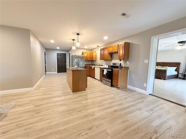 1307 Pike Dr, Bismarck, MO 63624 - kitchen featuring appliances with stainless steel finishes, baseboards, light wood-style floors, hanging light fixtures, and recessed lighting