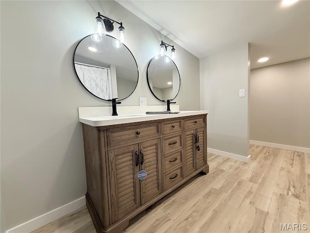 1307 Pike Dr, Bismarck, MO 63624 - full bathroom with double vanity, wood finished floors, and baseboards