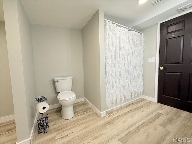 1307 Pike Dr, Bismarck, MO 63624 - bathroom featuring wood finished floors, toilet, and baseboards