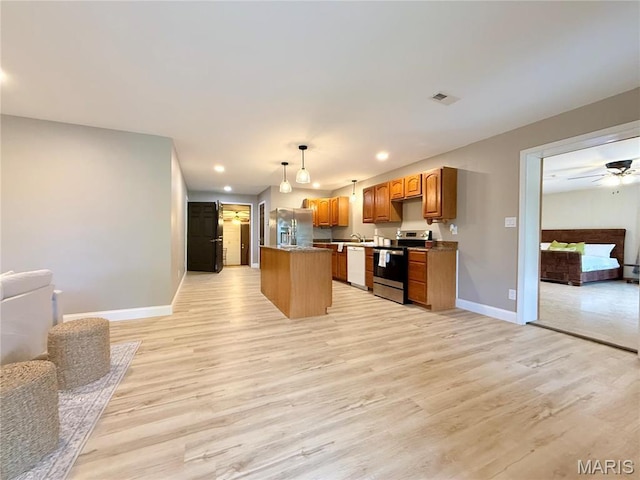 1307 Pike Dr, Bismarck, MO 63624 - kitchen featuring appliances with stainless steel finishes, open floor plan, light wood-type flooring, baseboards, and recessed lighting