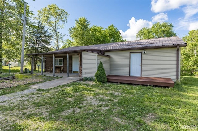 1307 Pike Dr, Bismarck, MO 63624 - back of house featuring a lawn, a wooden deck, and metal roof