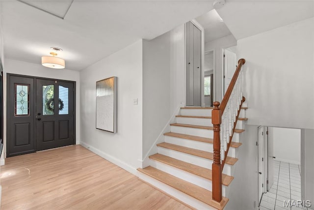 1 Woodoaks Trl, Saint Louis, MO 63124 - foyer with baseboards, light wood-type flooring, and stairway