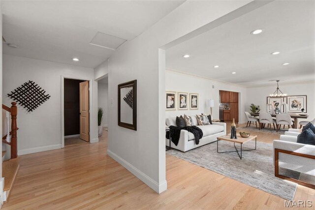 1 Woodoaks Trl, Saint Louis, MO 63124 - living area featuring light wood-type flooring, baseboards, recessed lighting, crown molding, and a chandelier