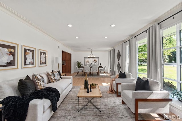 1 Woodoaks Trl, Saint Louis, MO 63124 - living room with healthy amount of natural light, light wood-style floors, a chandelier, recessed lighting, and ornamental molding