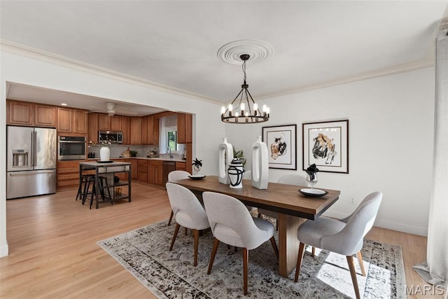 1 Woodoaks Trl, Saint Louis, MO 63124 - dining room featuring a chandelier, crown molding, light wood-type flooring, and baseboards