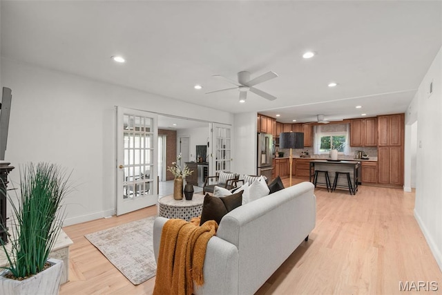 1 Woodoaks Trl, Saint Louis, MO 63124 - living area with light wood-type flooring, ceiling fan, recessed lighting, baseboards, and a fireplace with raised hearth