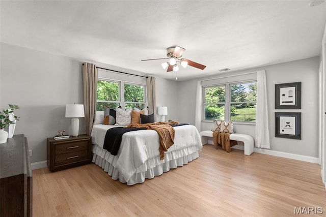 1 Woodoaks Trl, Saint Louis, MO 63124 - bedroom with multiple windows, light wood-style flooring, baseboards, and ceiling fan