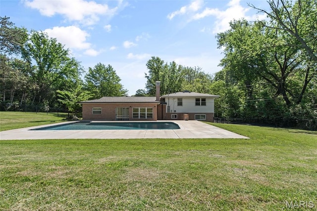 1 Woodoaks Trl, Saint Louis, MO 63124 - back of property with an outdoor pool, a patio area, view of wooded area, and brick siding