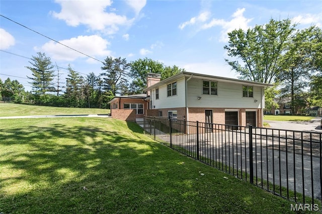 1 Woodoaks Trl, Saint Louis, MO 63124 - view of property exterior with a chimney, an attached garage, brick siding, and driveway