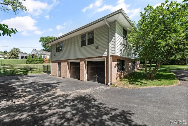 1 Woodoaks Trl, Saint Louis, MO 63124 - view of property exterior with driveway, an attached garage, and brick siding