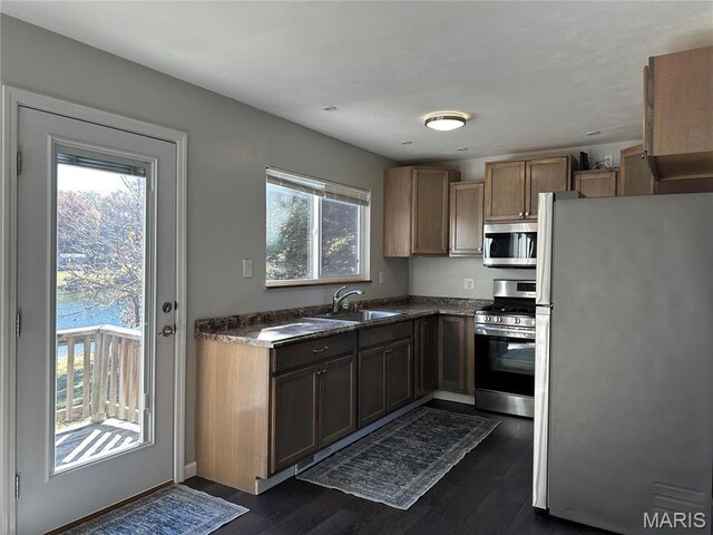 3985 Lakeshore Dr, New Haven, MO 63068 - kitchen with appliances with stainless steel finishes, a sink, dark wood-style flooring, and dark countertops