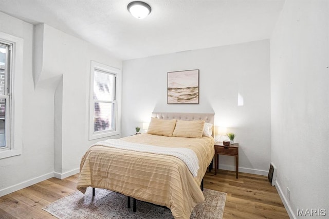3641 Virginia Ave, Saint Louis, MO 63118 - bedroom with wood finished floors, multiple windows, and baseboards
