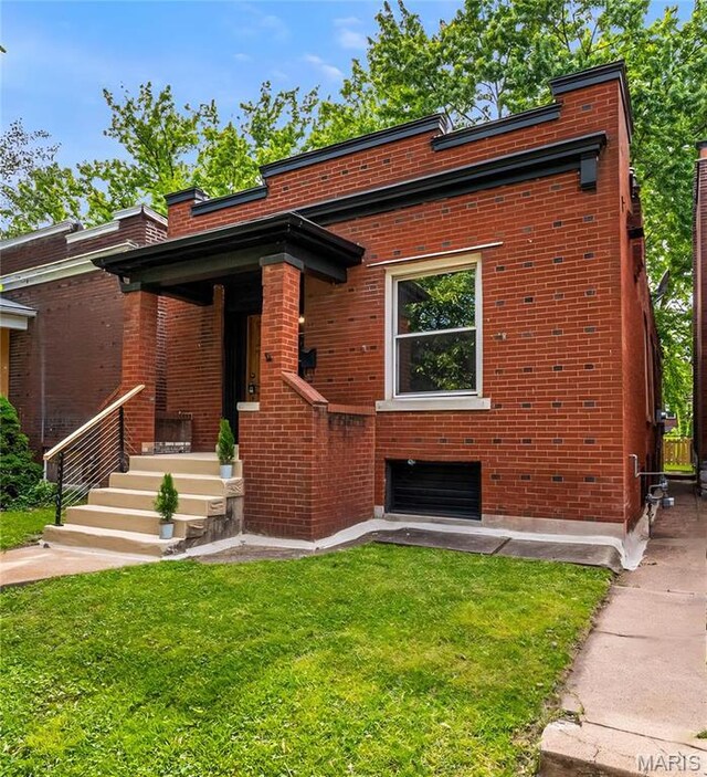 3641 Virginia Ave, Saint Louis, MO 63118 - view of front facade featuring brick siding, a front yard, and a chimney